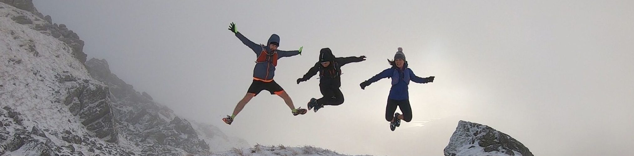 Simon, Derek and Christie jumping on the hillside