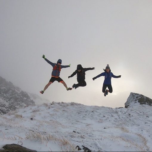 Simon, Derek and Christie jumping on the hillside