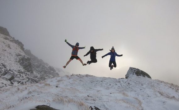 Simon, Derek and Christie jumping on the hillside
